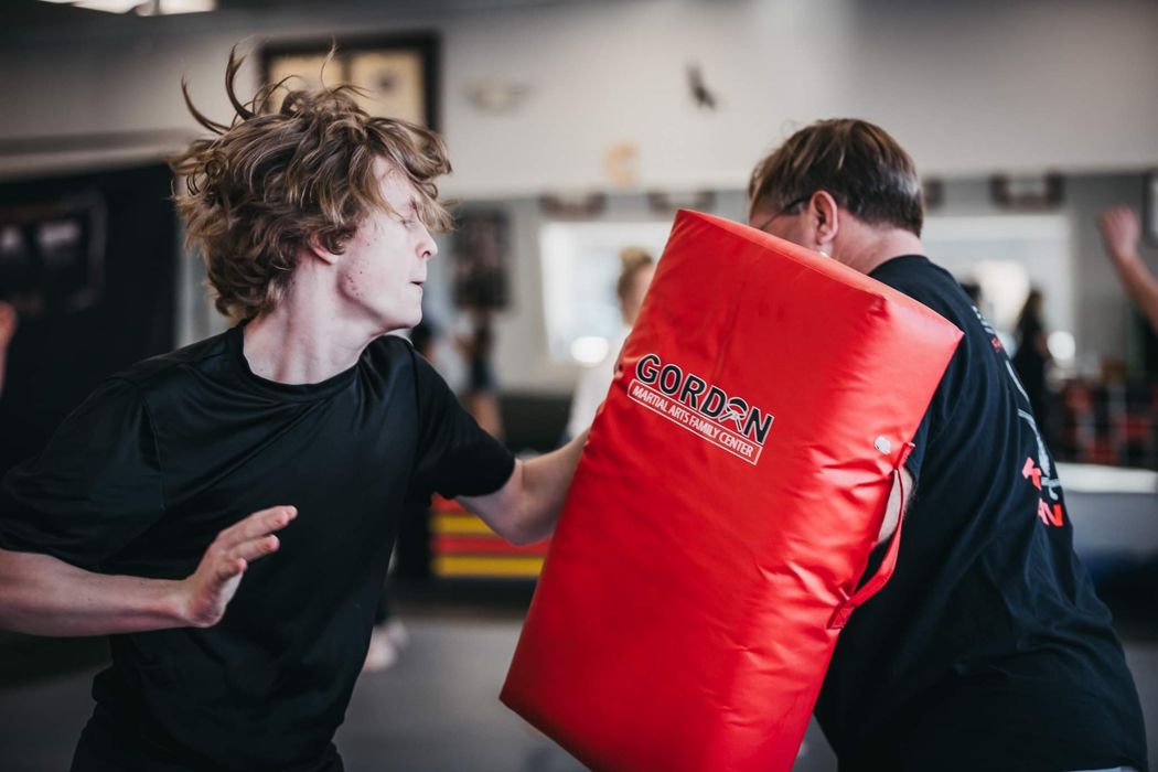 Student practicing pad strikes during class
